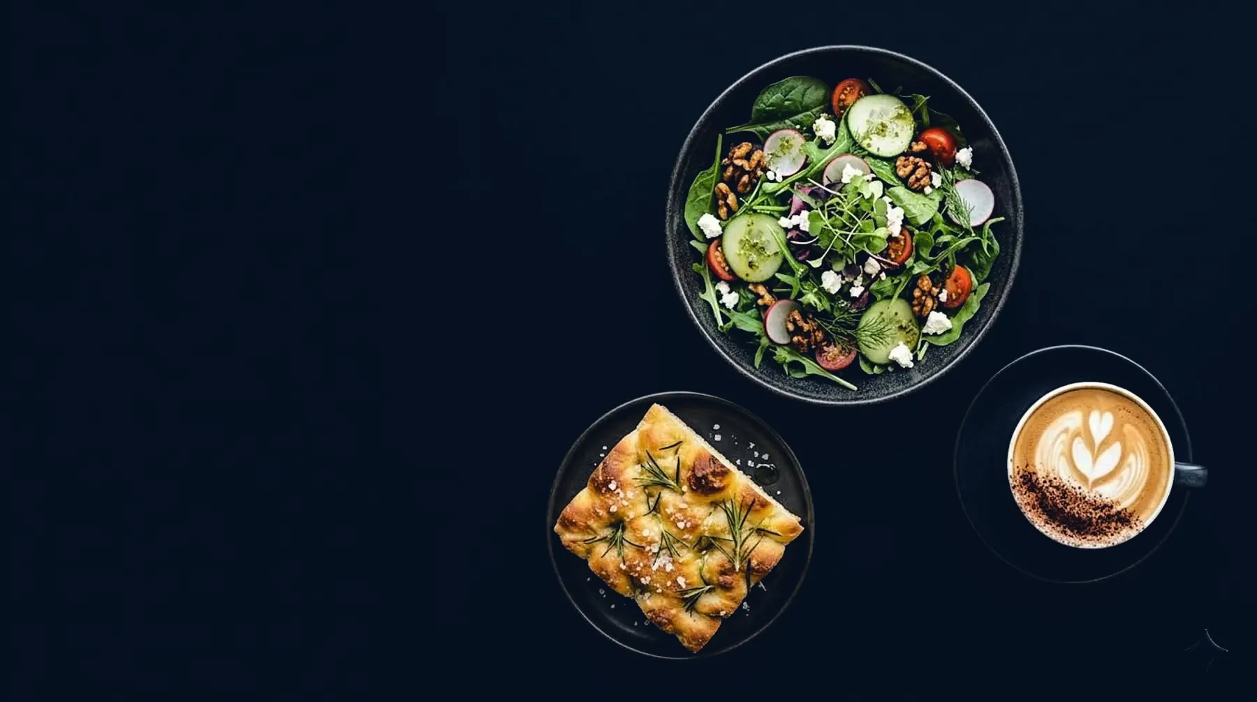 An assembled meal of salad, focaccia and cappuccino